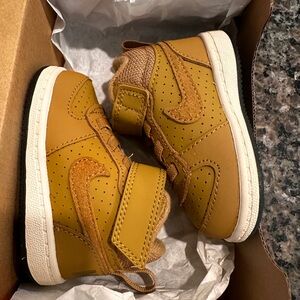 Baby Nike shoes in the color wheat